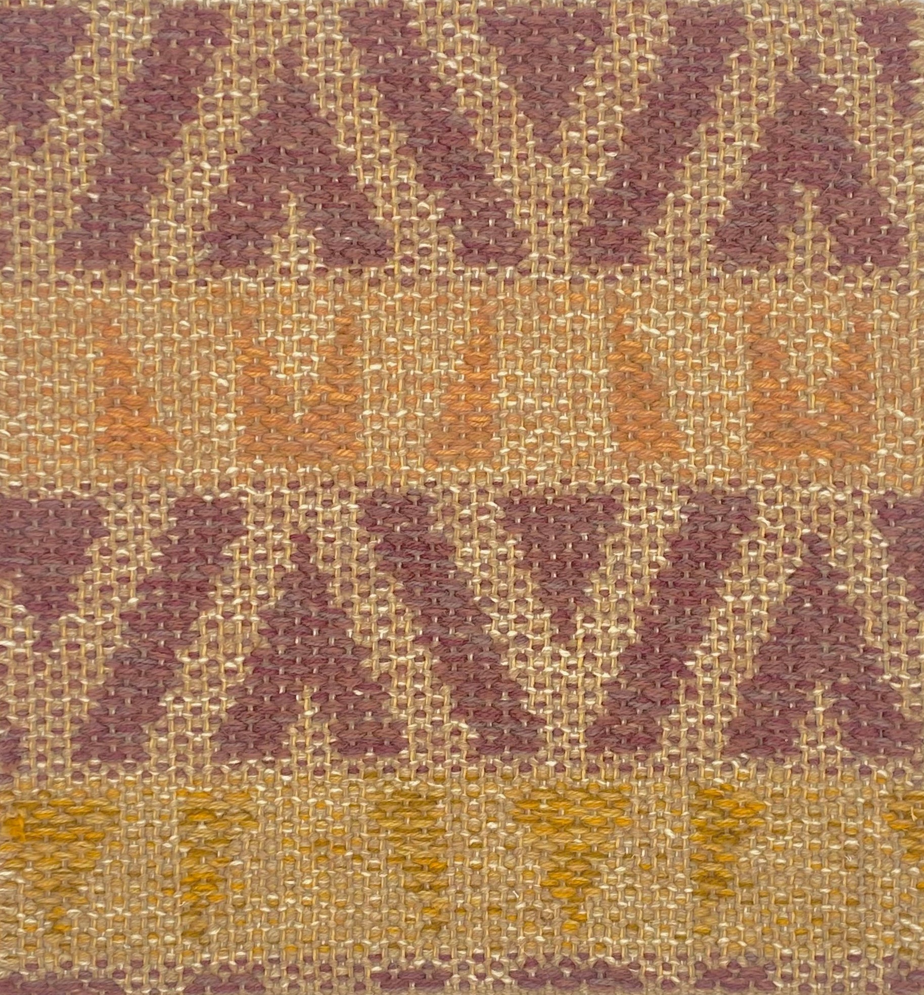 Flatweave rug in a playful geometric stripe design in yellow, coral and berry on a beige field