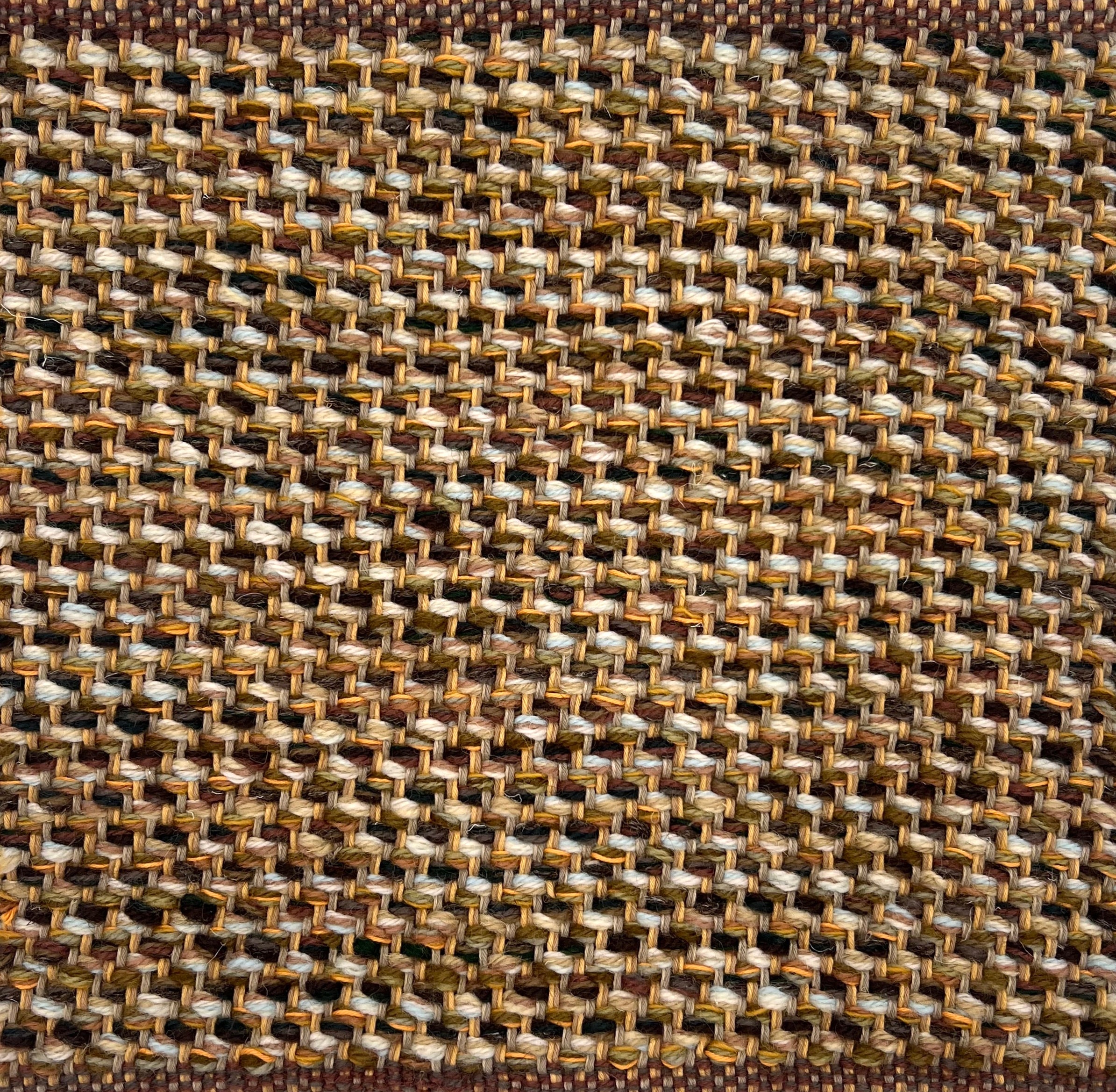 Textural flatweave rug in a strié twill weave in shades of brown, tan and cream.