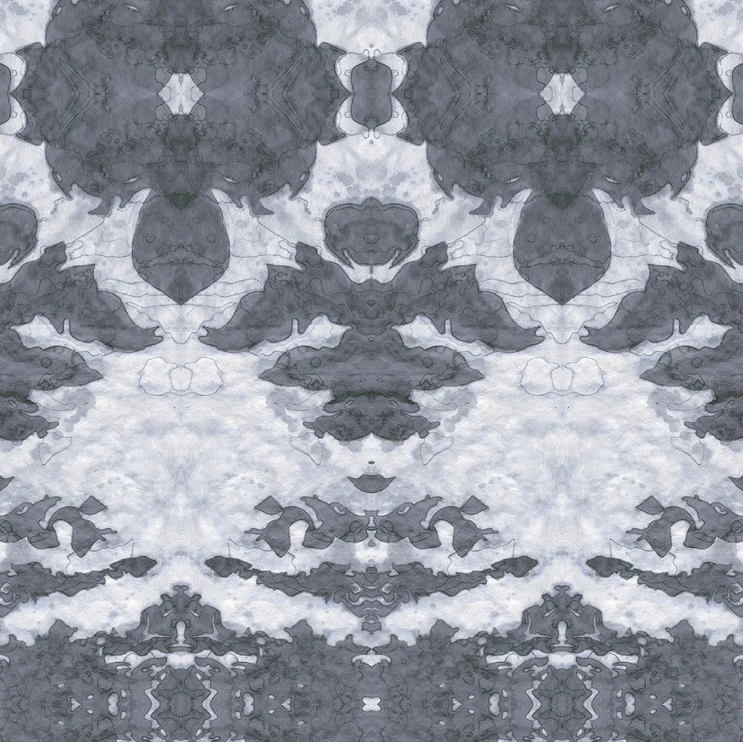 Detail of wallpaper in a painterly ikat print in shades of gray and light blue.