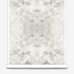 Partially unrolled wallpaper yardage in a watercolor textural print in shades of cream, gray and tan.