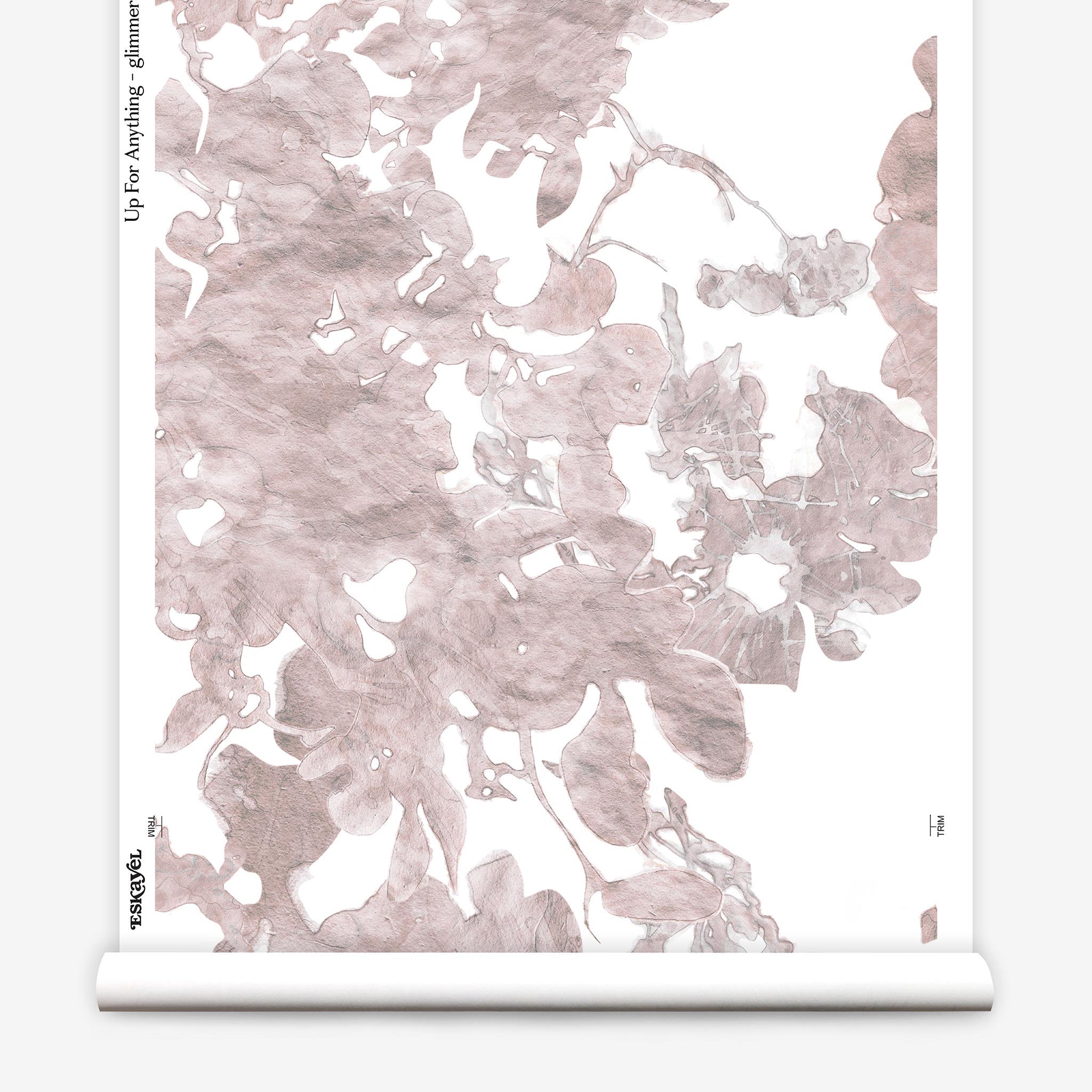 Partially unrolled wallpaper yardage in a watercolor floral print in mottled pink and gray on a white field.