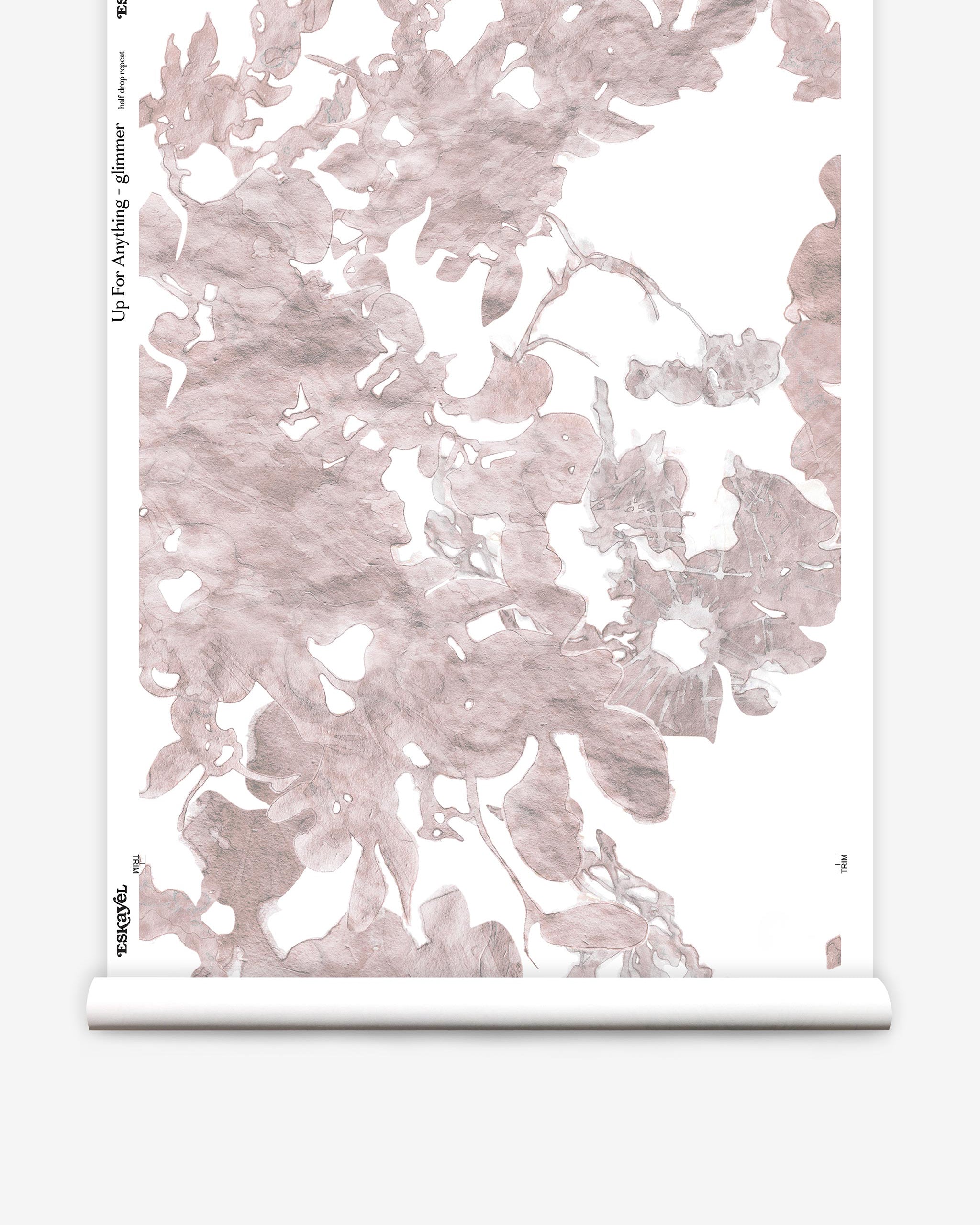 Partially unrolled wallpaper yardage in a watercolor floral print in mottled pink and gray on a white field.