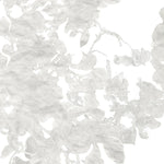 Detail of wallpaper in a watercolor floral print in mottled cream and gray on a white field.