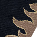 Detail of a flatweave rug with a flame border design in taupe on a black