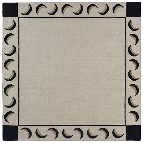 Flatweave rug with a crescent moon border in cream, taupe and black.