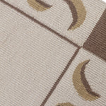 Detail of a flatweave runner with a crescent moon border in cream, taupe and brown