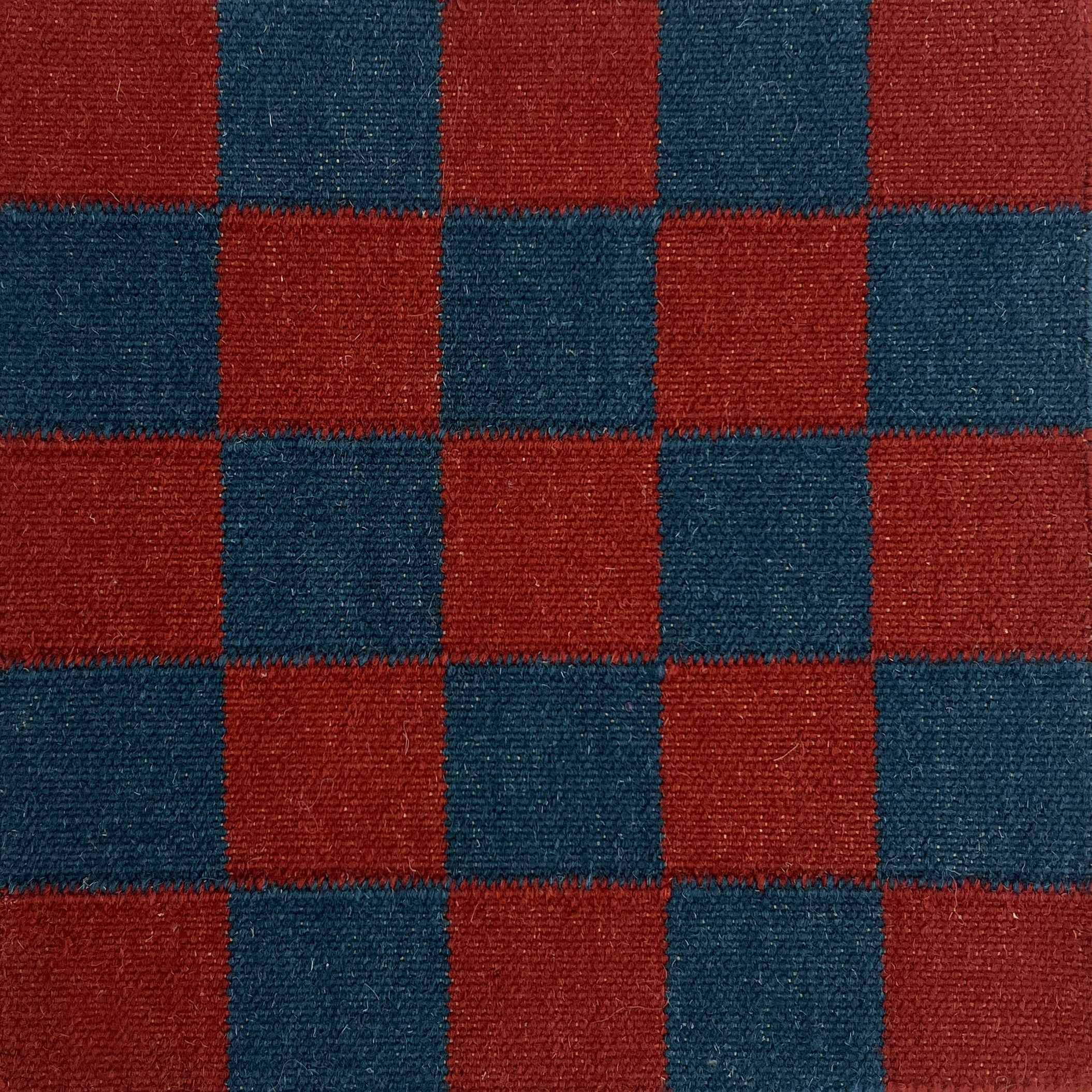 Flatwoven checkerboard rug in blue and red.