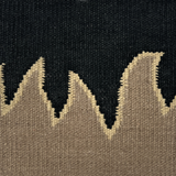 Detail of a flatweave rug with a flame border design in taupe on a black