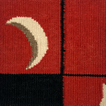 Detail of a flatweave runner with a crescent moon border in cream, taupe and black of a red field.
