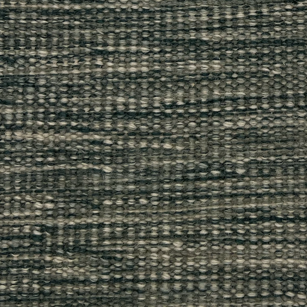 Flatweave rug in a textural strié weave in green and teal.