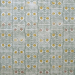 Wallpaper in a repeating damask print in mustard and white on a blue-gray field.