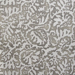 Wallpaper in a botanical paisley print in white on a light brown field.