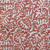Wallpaper in a botanical paisley print in cream on a mottled red field.
