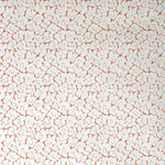 Wallpaper in a minimal floral print in blue and rust on a cream field.