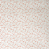 Wallpaper in a minimal floral print in blue and rust on a cream field.