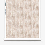 Wallpaper roll in a layered squiggle watercolor pattern in shades of pastel pink. 