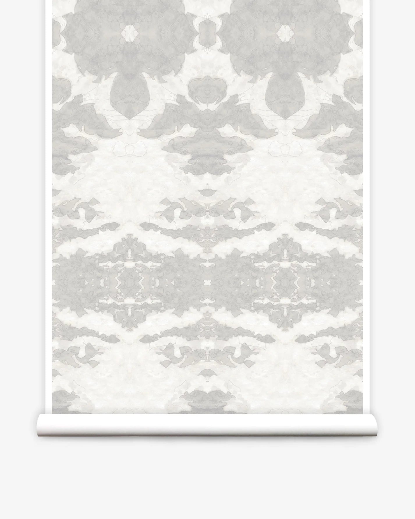 Partially unrolled wallpaper yardage in a painterly ikat print in shades of gray and cream.