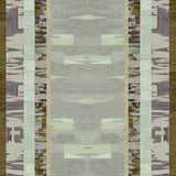 Printed fabric in an engineered stripe design with watercolor effects in shades of shades of green, sea foam, purple and brown.