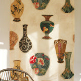 Rattan chair in front a of a printed fabric panel with ornate decorative urns.