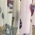 Detail of a curtain Rattan in a printed fabric panel with ornate decorative urns.