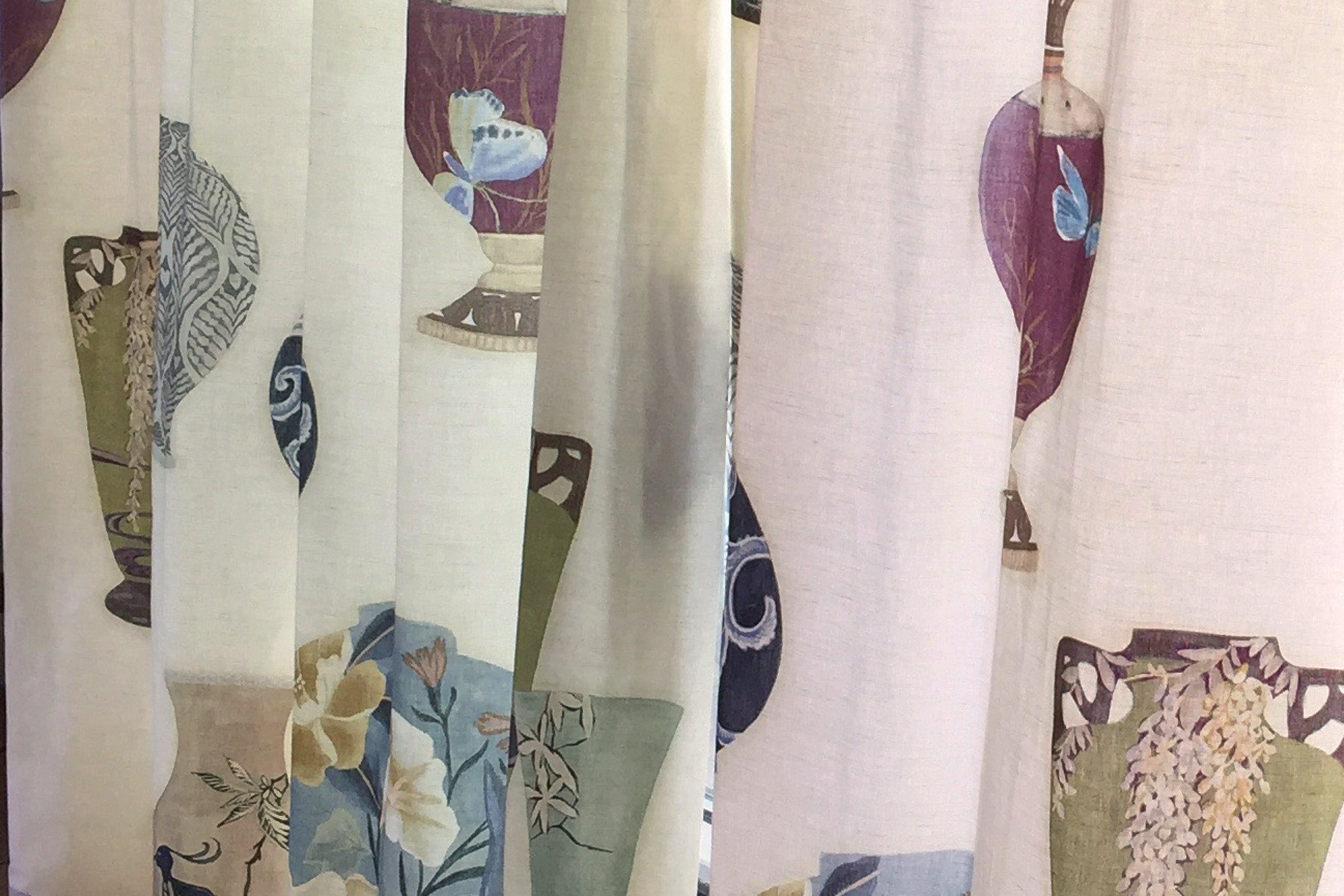 Detail of a curtain Rattan in a printed fabric panel with ornate decorative urns.