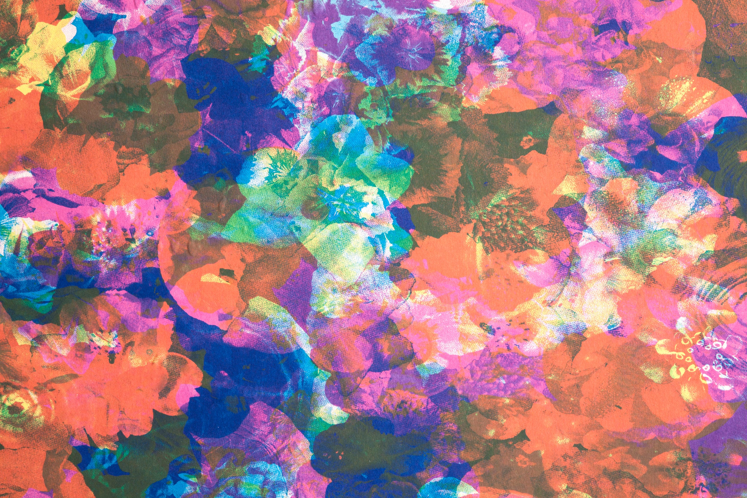Detail of wallpaper in a dense photorealistic floral print in multicolor neon shades.