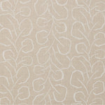 Woven fabric swatch with a large-scale repeating leaf print in white on a cream background.