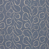 Woven fabric swatch with a large-scale repeating leaf print in tan on a French blue background.