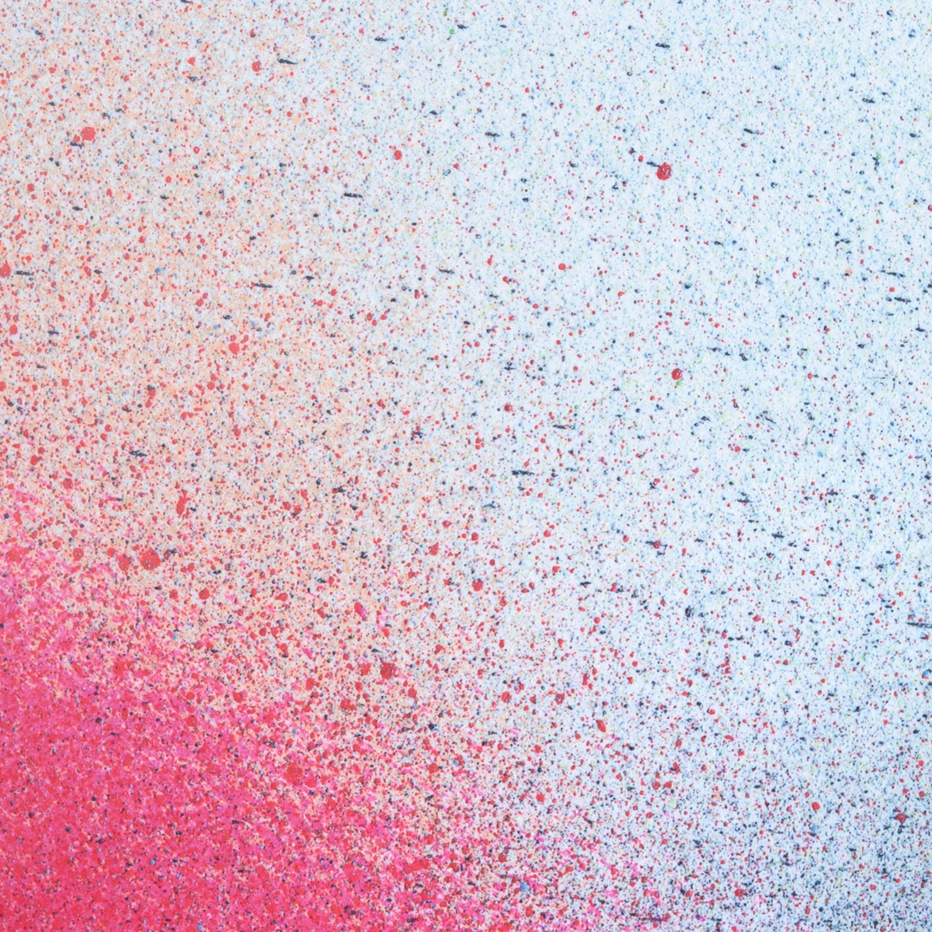 Close up of paint splatters in red and blue.