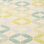 Detail of Alhambra Rug in Mint featuring a pattern of linked circles that create a star like lattice in a range of pastel turquoise, mint, yellow and lime green on a soft beige field. 