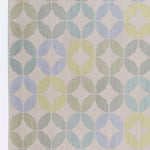 Detail of Alhambra Rug in Mint featuring a pattern of linked circles that create a star like lattice in a range of pastel turquoise, mint, yellow and lime green on a soft beige field. 