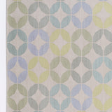Detail of Alhambra Rug in Mint featuring a pattern of linked circles that create a star like lattice in a range of pastel turquoise, mint, yellow and lime green on a soft beige field. 