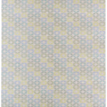 Detail of Alhambra Rug in Mint featuring a pattern of linked circles that create a star like lattice in a range of pastel turquoise, mint, yellow and lime green on a soft beige field. 