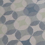 Detail of Alhambra Rug in Seafret featuring pattern of linked circles that create a star like lattice in a range of pale blues, with a light green accent on a soft white field. 