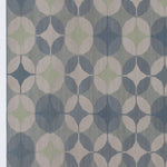 Detail of Alhambra Rug in Seafret featuring pattern of linked circles that create a star like lattice in a range of pale blues, with a light green accent on a soft white field. 