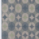 Detail of Alhambra Rug in Seafret featuring pattern of linked circles that create a star like lattice in a range of pale blues, with a light green accent on a soft white field. 