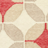 Detail of Alhambra Rug in Tomato featuring pattern of linked circles that create a star like lattice in a range of tan, beige, ecru and bright red on a soft white field. 