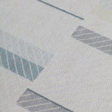 Detail of the Amelia Rug in Pearl featuring a minimalist broken stripe pattern, overlayed with thin white diagonal lines. The broken stripes are a mix of pale blues, grey, and turquoise with slate grey accents, all on a pale grey field. 