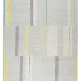 Full size Amelia Rug in Peridot featuring a minimalist broken stripe pattern, overlayed with thin white diagonal lines. The broken stripes are a mix of white, grey, and shades of yellow with kelly green accents, all on a light grey field. 