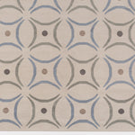 Detail of the Boe rug in Genoa, featuring a pattern of curved segments in light blue and sage green with taupe circles on an ivory field. 