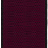 Full size Bucky Rug in berry, features a wide black border with a wine colored lattice field with a metallic sheen. 
