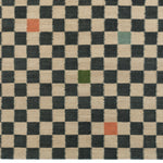 Detail of the Checkerboard Rug in King, a black and tan checkered pattern with random accents of green, sky blue and coral orange. 