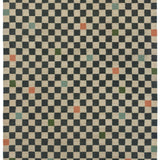 Detail of the Checkerboard Rug in King, a black and tan checkered pattern with random accents of green, sky blue and coral orange. 