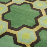 Detail of the Cordoba Cut Pile Rug in Emerald, a hexagonal lattice pattern with sahdes of emerald, jade, yelow and chcolate brown. 
