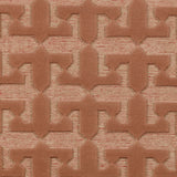 Detail of the Iseo Rug in Conch, a textural monochromatic abstract geometric pattern in terracotta coral color. 