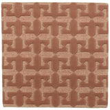 Detail of the Iseo Rug in Conch, a textural monochromatic abstract geometric pattern in terracotta coral color. 