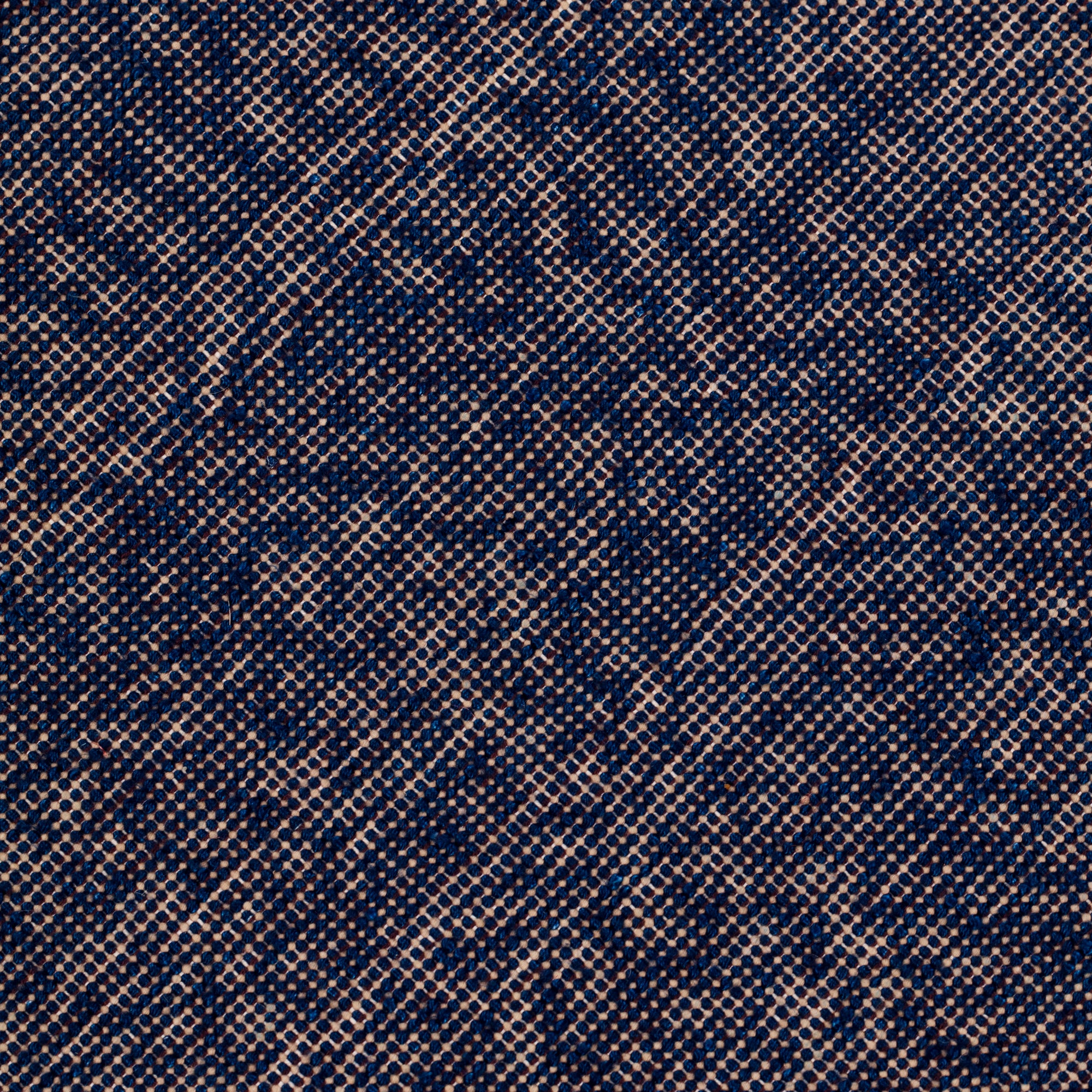 Detail of the Penta Rug in Tempestl, a subtle striated pattern in indigo blue and taupe. 