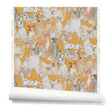 Partially unrolled wallpaper with a pattern of many different types of illustrated watercolor dogs. Background is mustard.