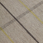 Detail of the Jasper Waffle Rug in Peridot, a large scale plaid pattern of ecru, yellow, grey and off white. 