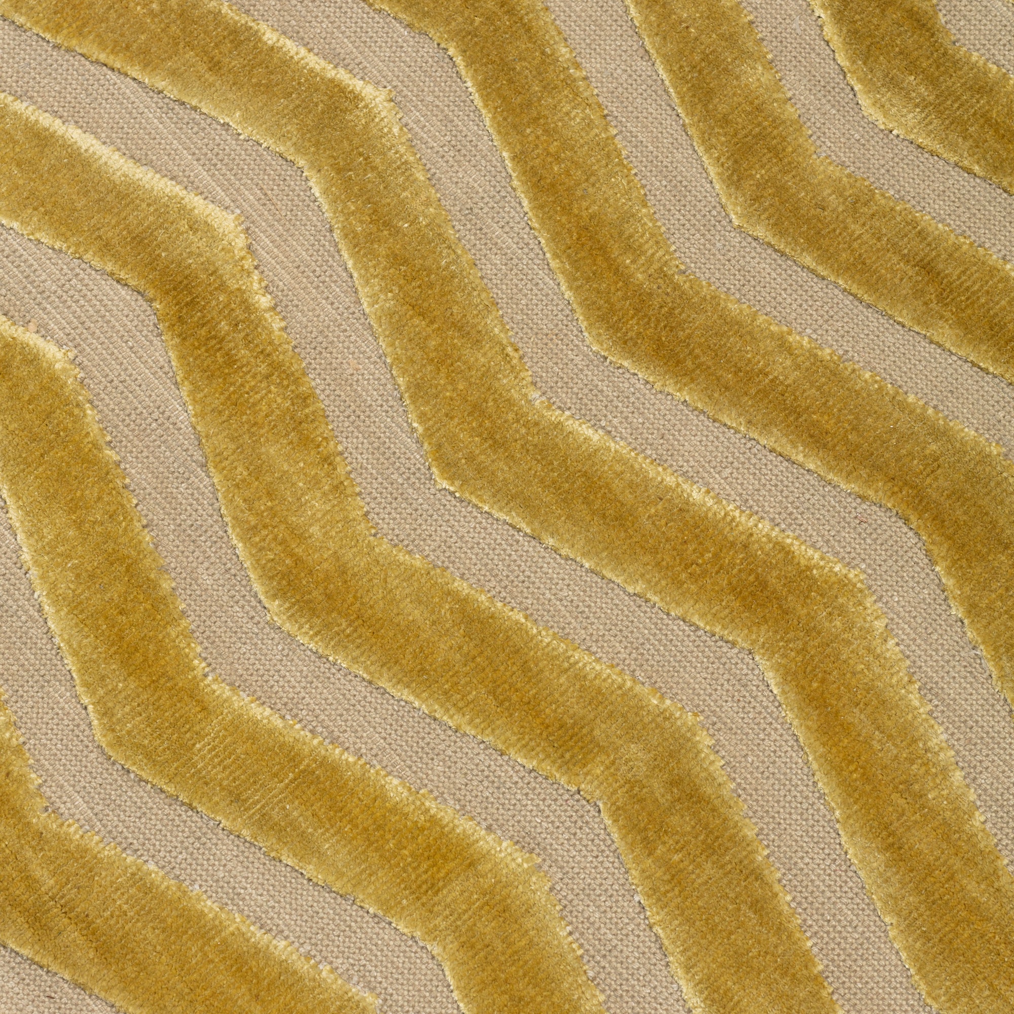 Detail of the Penta Chevron Rug in Lemon Topaz a lemon yellow chevron pattern on a taupe field with a wide solid border. 